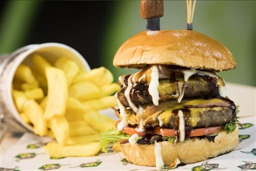 A burger stacked high, with chips