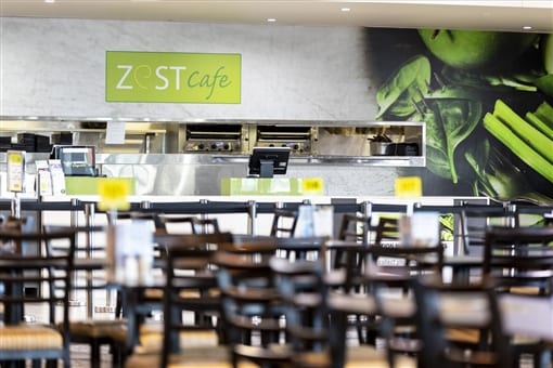 The Zest cafe counter and dining room, with rows of tables and chairs